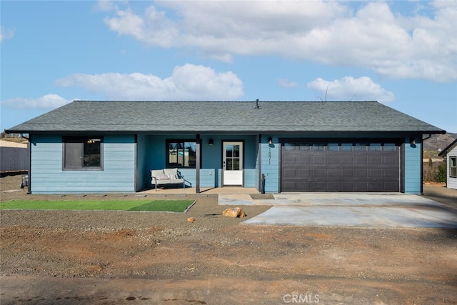 ranch-style home featuring a garage and a porch