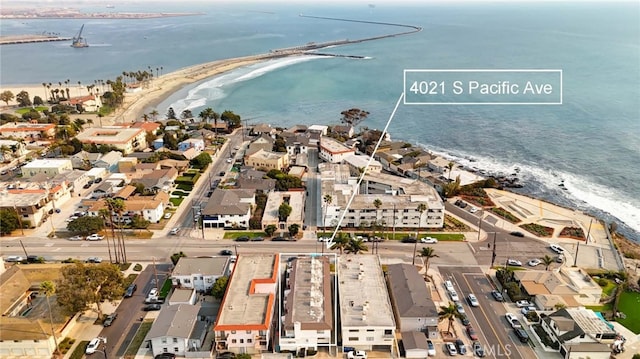 birds eye view of property featuring a water view and a view of the beach