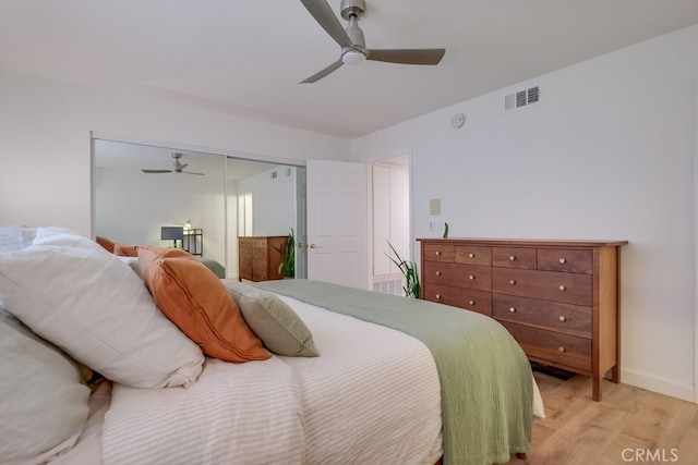 bedroom featuring ceiling fan, a closet, and light hardwood / wood-style flooring