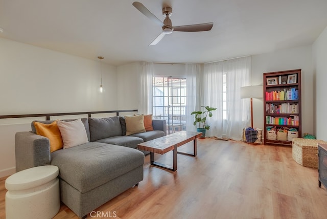 living room featuring ceiling fan and light hardwood / wood-style floors