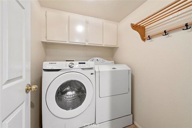 laundry room featuring cabinet space and washing machine and dryer