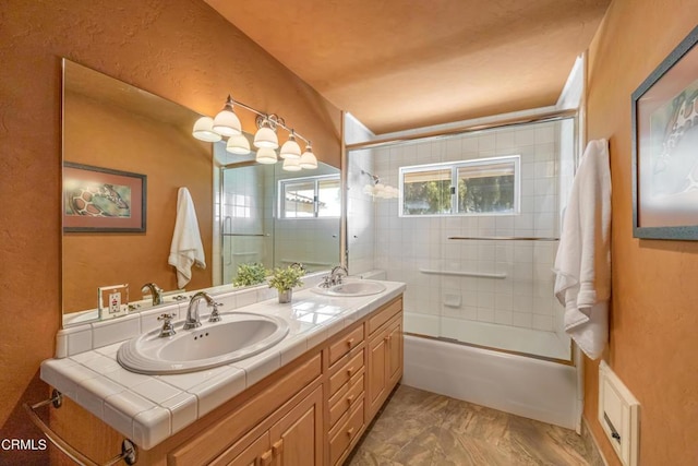 bathroom with combined bath / shower with glass door and vanity