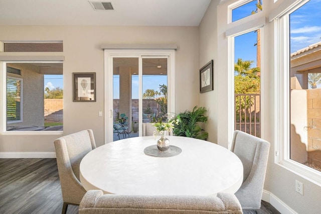 dining room featuring dark hardwood / wood-style floors and plenty of natural light