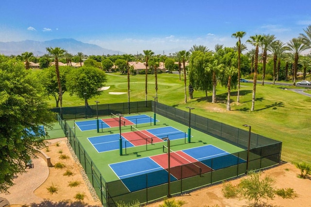 view of sport court featuring tennis court and a mountain view