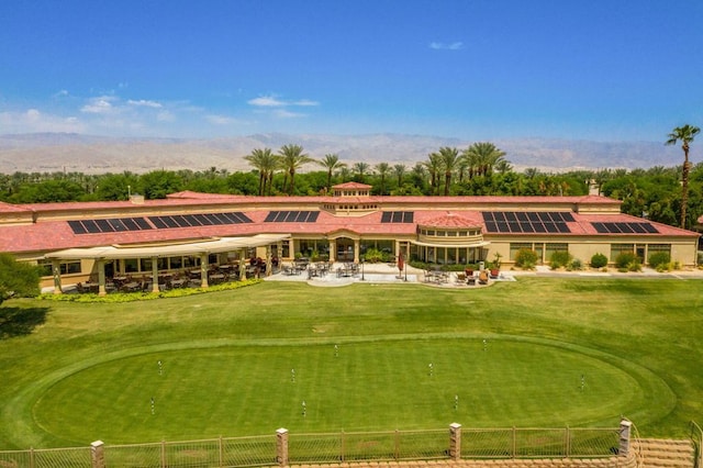 view of property's community featuring a mountain view and a lawn