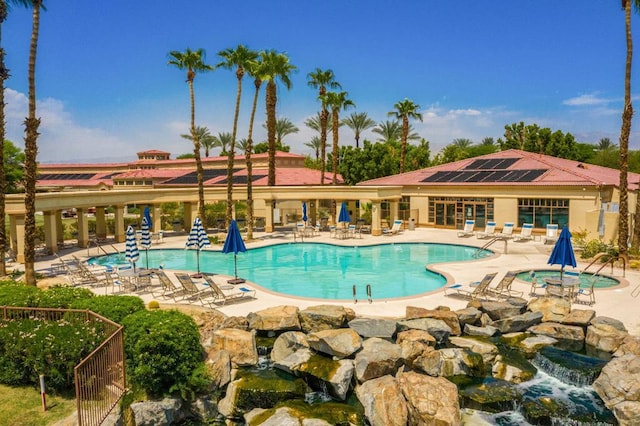 view of swimming pool with a patio area and a community hot tub