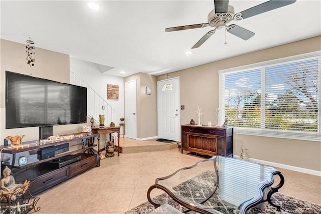 living room with ceiling fan and light tile patterned flooring