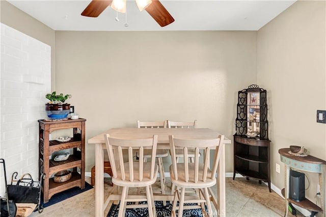 dining space with ceiling fan and light tile patterned flooring