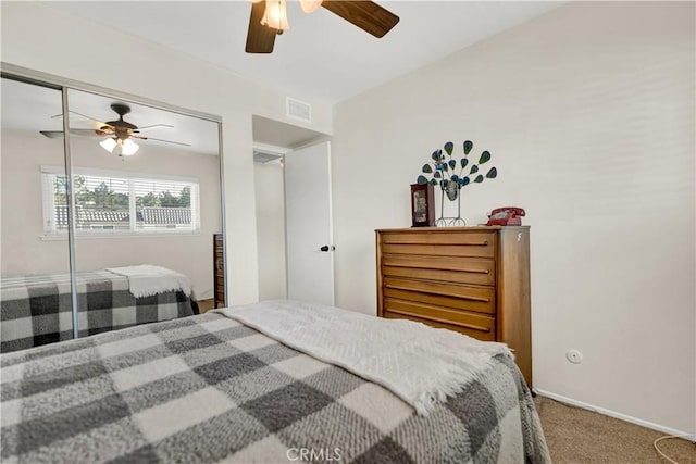 carpeted bedroom with ceiling fan and a closet