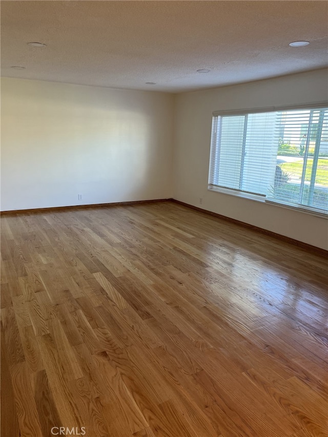 unfurnished room featuring light hardwood / wood-style flooring