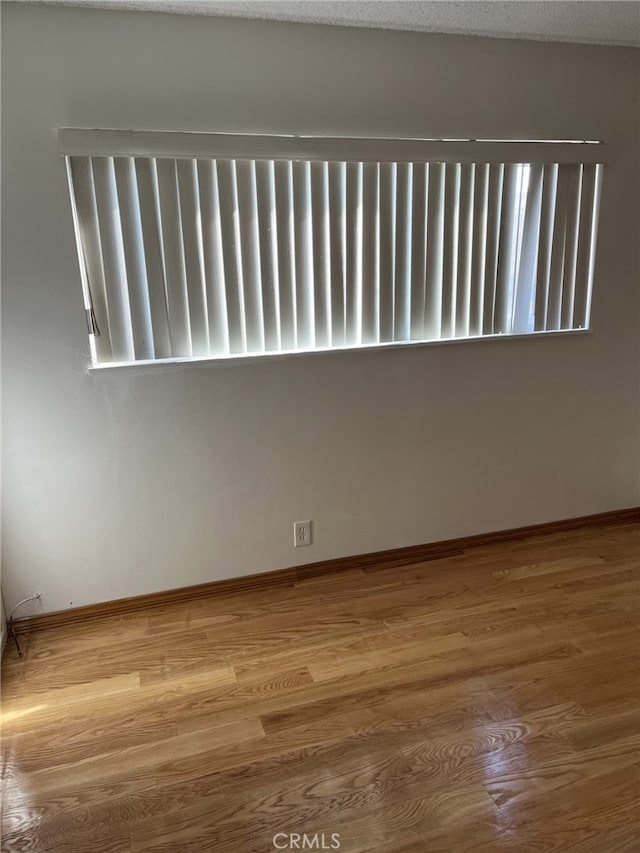 unfurnished room featuring hardwood / wood-style floors