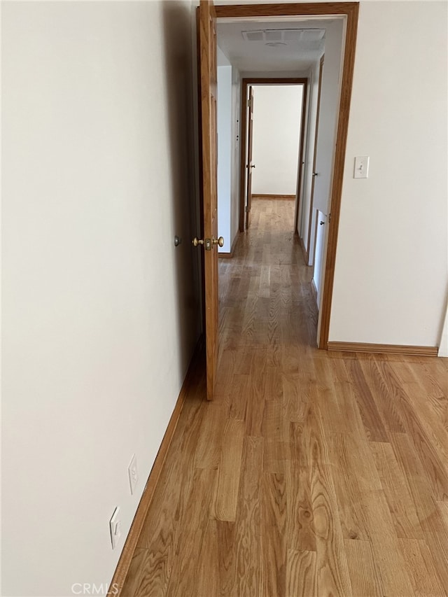 hallway with light hardwood / wood-style flooring