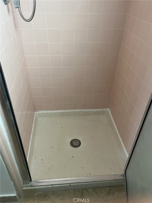 bathroom with a tile shower