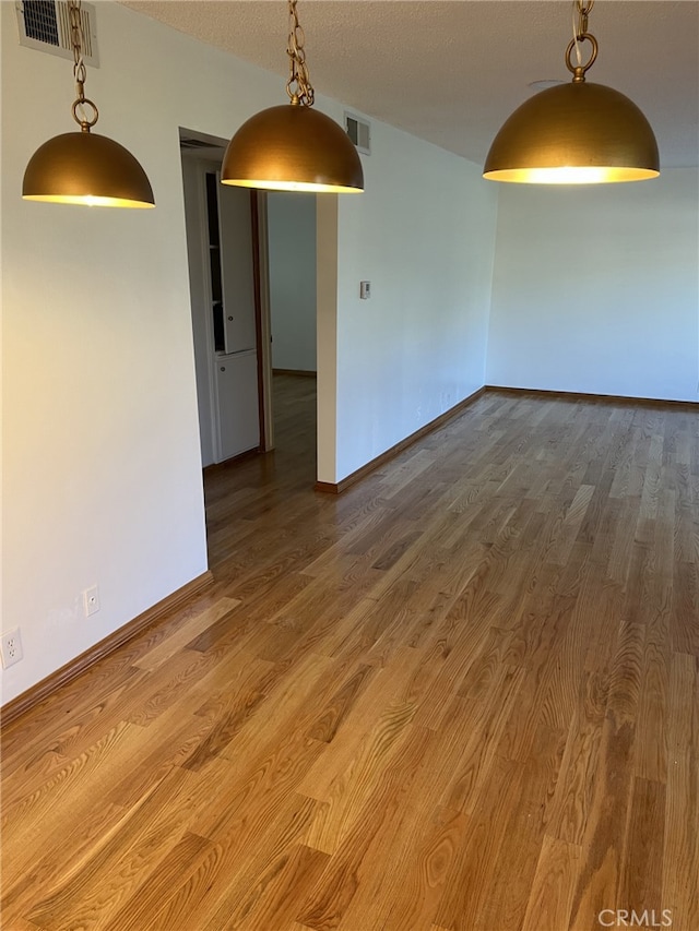 unfurnished room with wood-type flooring