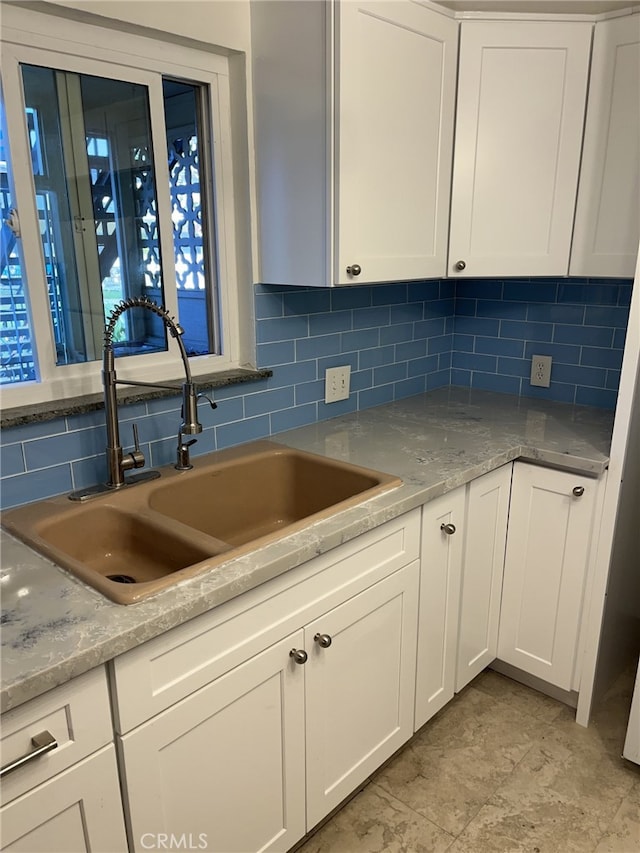 kitchen with white cabinets and backsplash