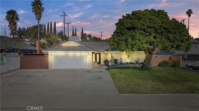 view of front of house with a garage and a yard