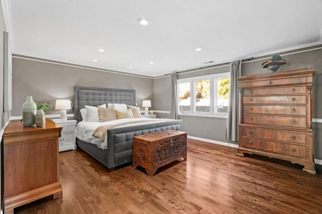 bedroom featuring dark wood-type flooring and ornamental molding