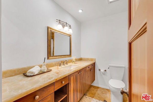 bathroom featuring toilet, tile patterned flooring, and vanity