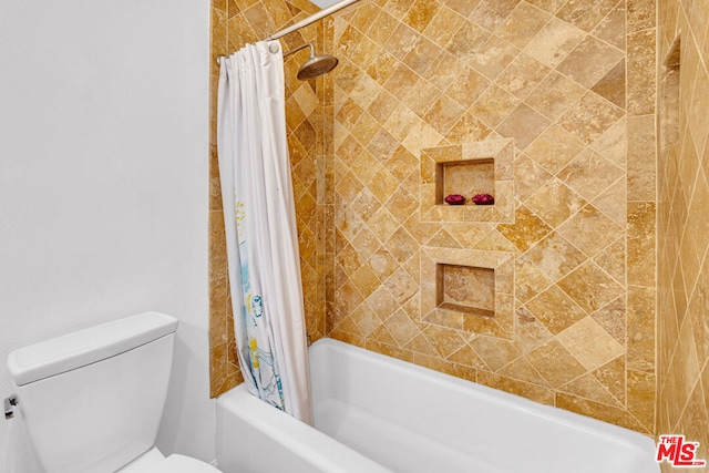 bathroom featuring toilet and shower / bath combo