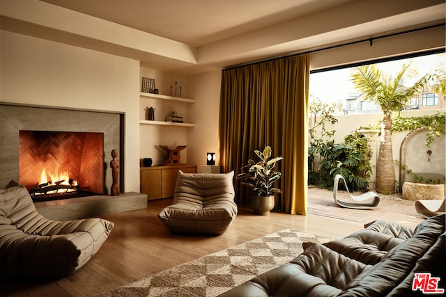 living area featuring light hardwood / wood-style floors and built in shelves