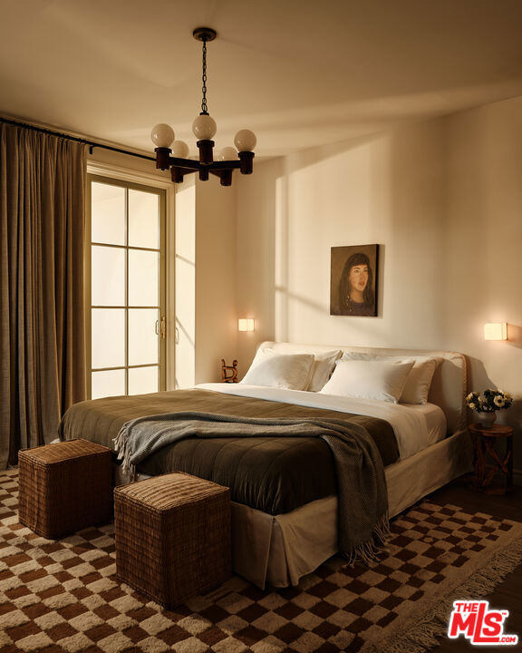 bedroom featuring a notable chandelier