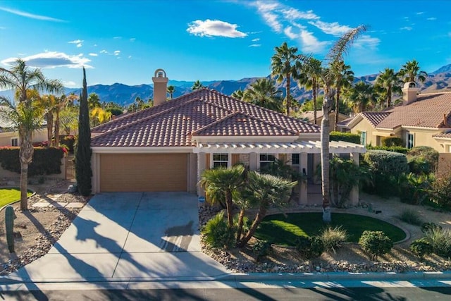 mediterranean / spanish-style house featuring a mountain view and a garage