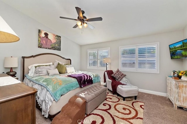 bedroom with ceiling fan, vaulted ceiling, and carpet floors