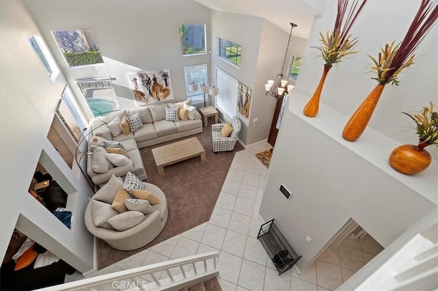 tiled living room with a high ceiling and a notable chandelier