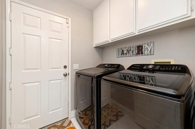 washroom with cabinets, washer and dryer, and tile patterned flooring