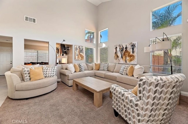 living room featuring tile patterned flooring and a towering ceiling