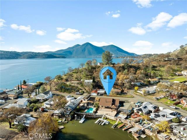 birds eye view of property featuring a water and mountain view