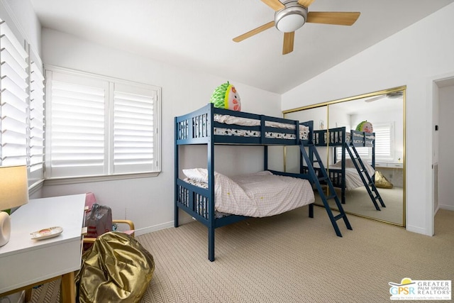 carpeted bedroom featuring ceiling fan, lofted ceiling, and a closet