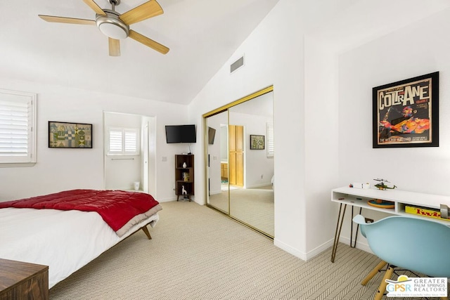 bedroom featuring ceiling fan, carpet flooring, a closet, and vaulted ceiling