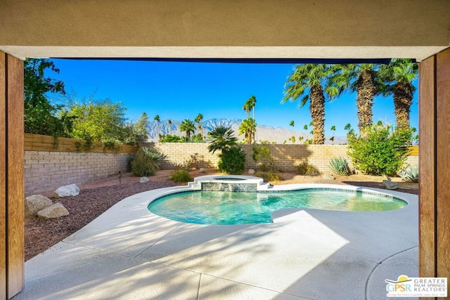 view of pool with central AC, a patio area, and an in ground hot tub