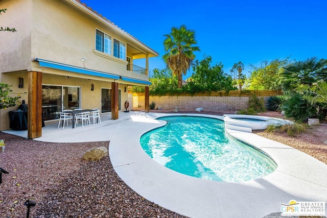 view of pool featuring an in ground hot tub and a patio