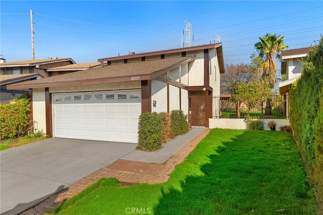 view of front facade with a garage and a front lawn