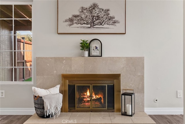 interior details featuring a premium fireplace and hardwood / wood-style floors