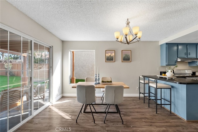 dining area with a textured ceiling, dark hardwood / wood-style flooring, and a chandelier