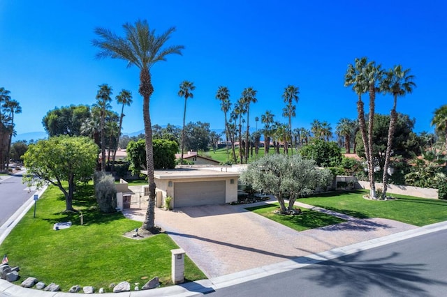 view of front of house with a front yard and a garage