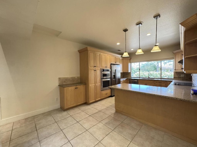 kitchen with pendant lighting, stainless steel appliances, backsplash, kitchen peninsula, and light tile patterned floors