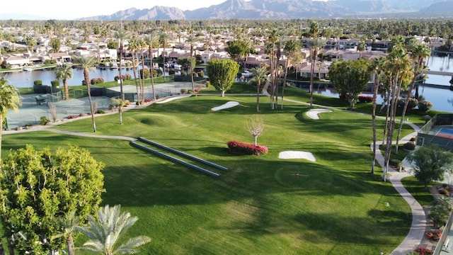 surrounding community with a water and mountain view