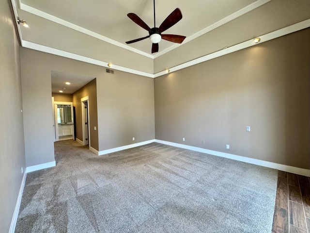 carpeted empty room featuring ceiling fan and crown molding