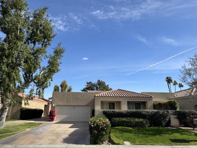 view of front of home with a front yard and a garage