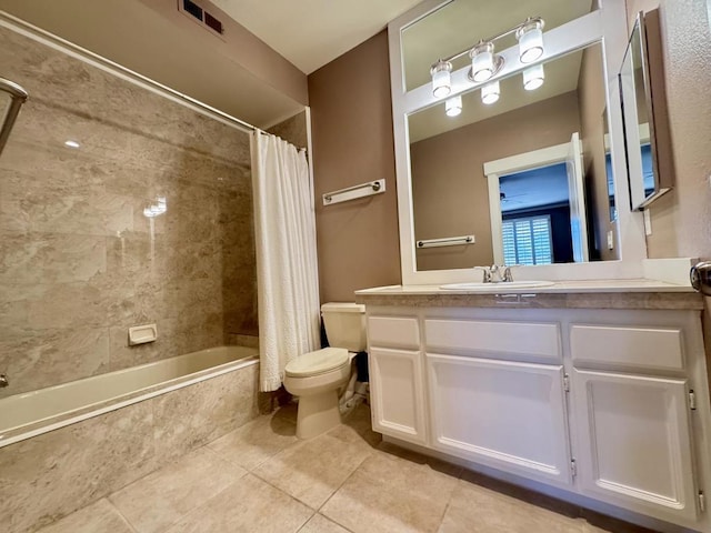 full bathroom featuring toilet, tile patterned flooring, vanity, and shower / bath combo with shower curtain