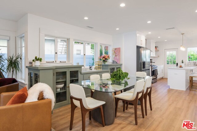 dining space featuring light wood-type flooring