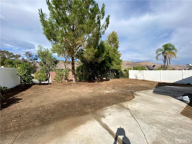 view of yard with a mountain view and a patio area