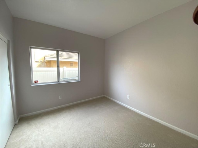 empty room featuring light carpet