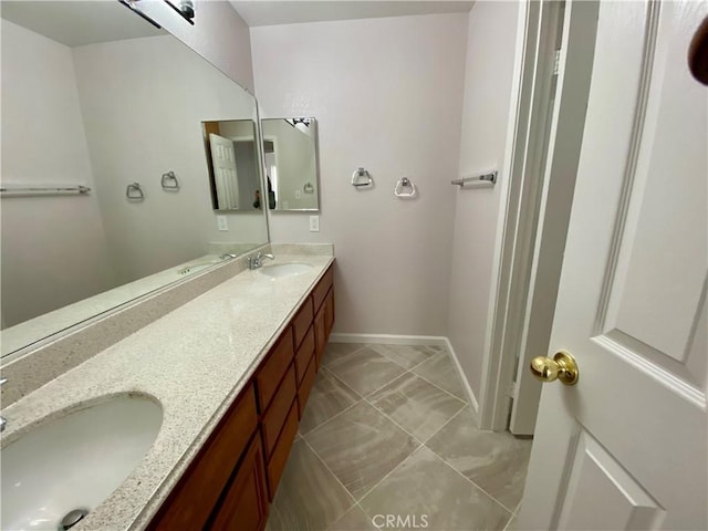 bathroom featuring tile patterned flooring and vanity