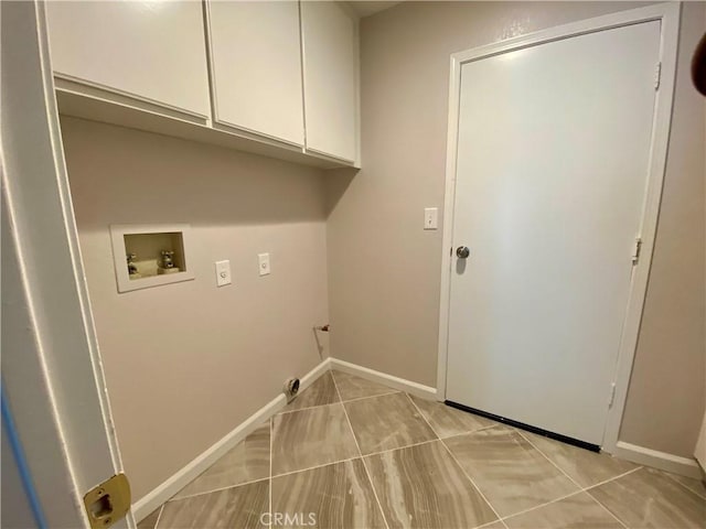 laundry area with cabinets, light tile patterned floors, and hookup for a washing machine