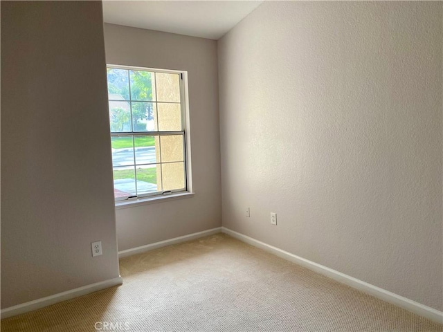 unfurnished room with carpet and a healthy amount of sunlight